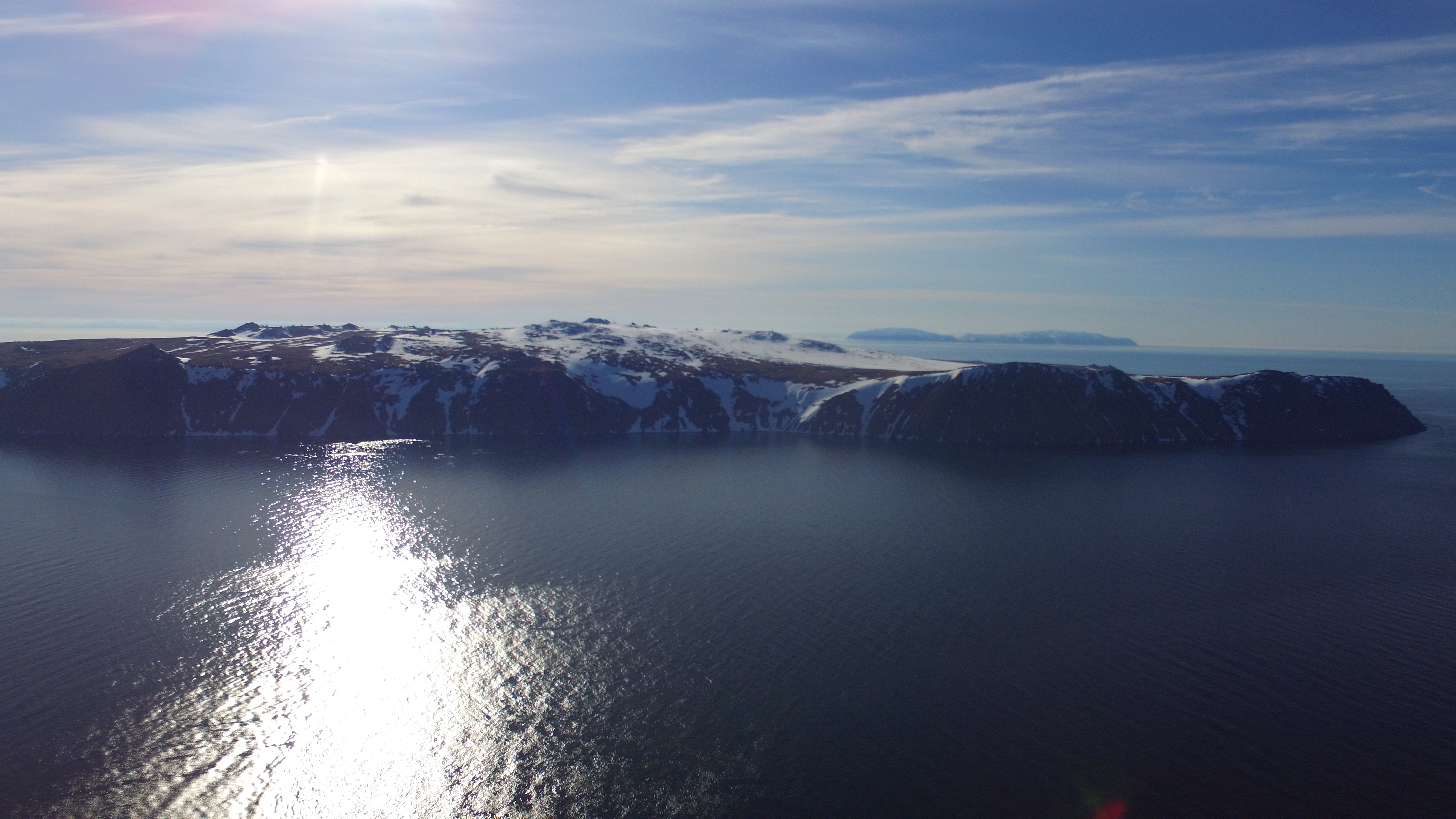 Big Diomede Island with mainland Russia In Background